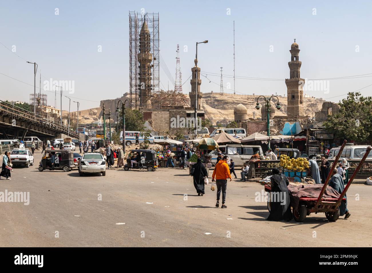 People and cars crossing a busy road in Cairo, Egypt Stock Photo