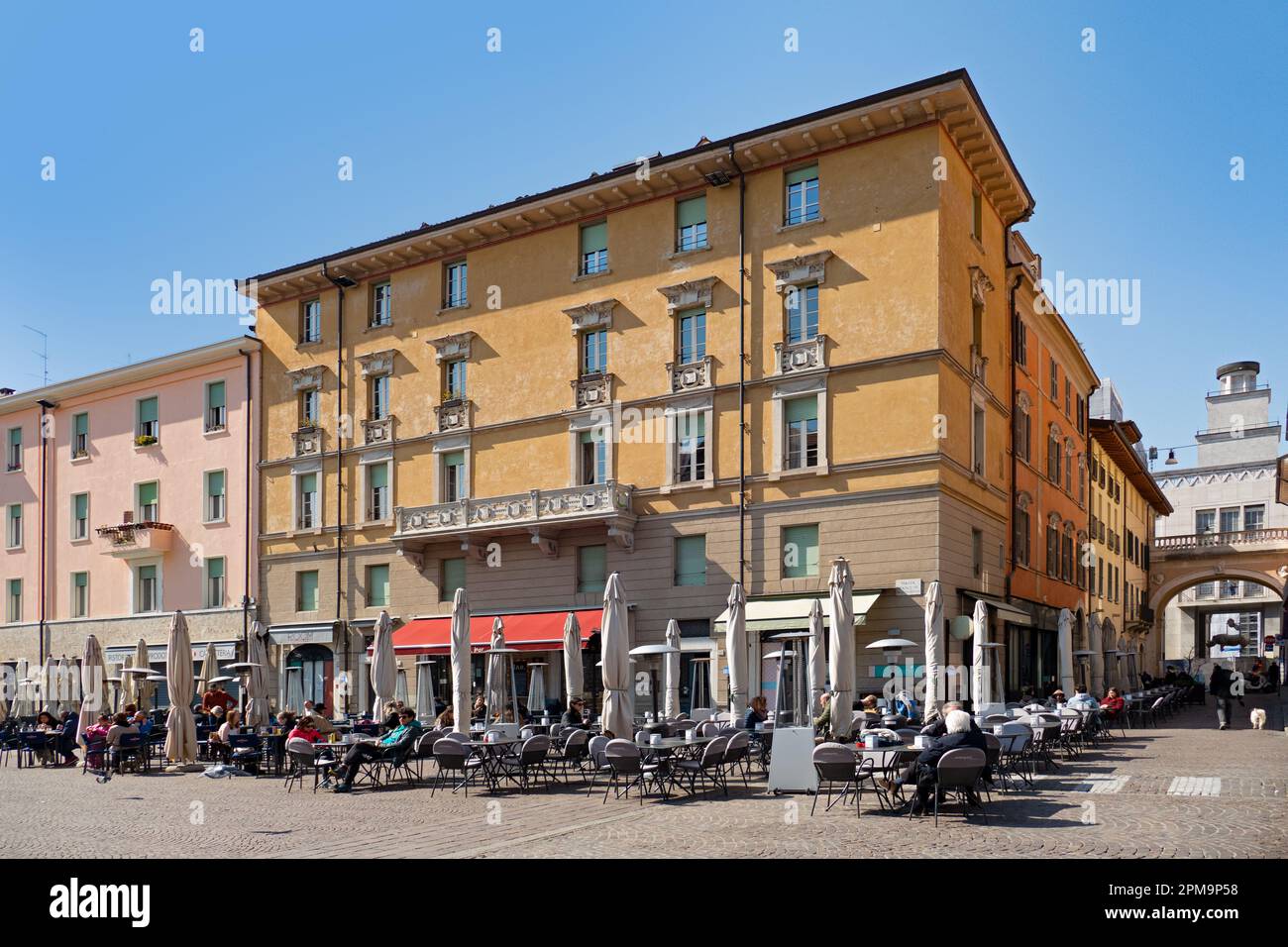 Brescia, Italy - March 22, 2022: people enjoy the warm spring day at Piazza Paolo in Brescia, Italy. Stock Photo