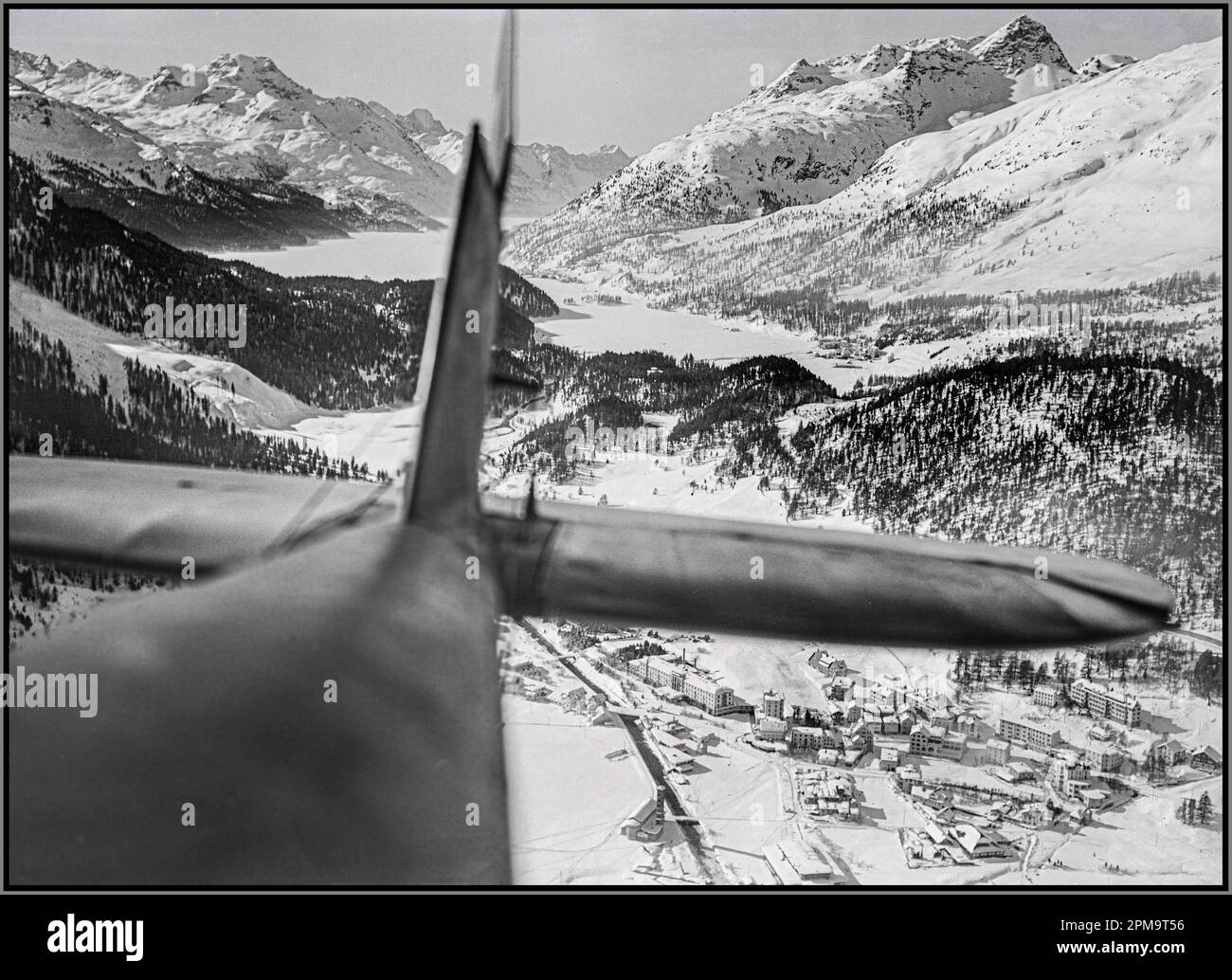Vintage St. Moritz under snow viewed from an airplane at 400m, Lake Sils, Maloja, Switzerland 1919 by  Walter Mittelholzer  (1894–1937)  Swissair Fokker F.VII a at the  Lake St. Moritz Description: Sightseeing flights mainly took place in the early 1930s, with Swissair between 1932 and 1934 Stock Photo
