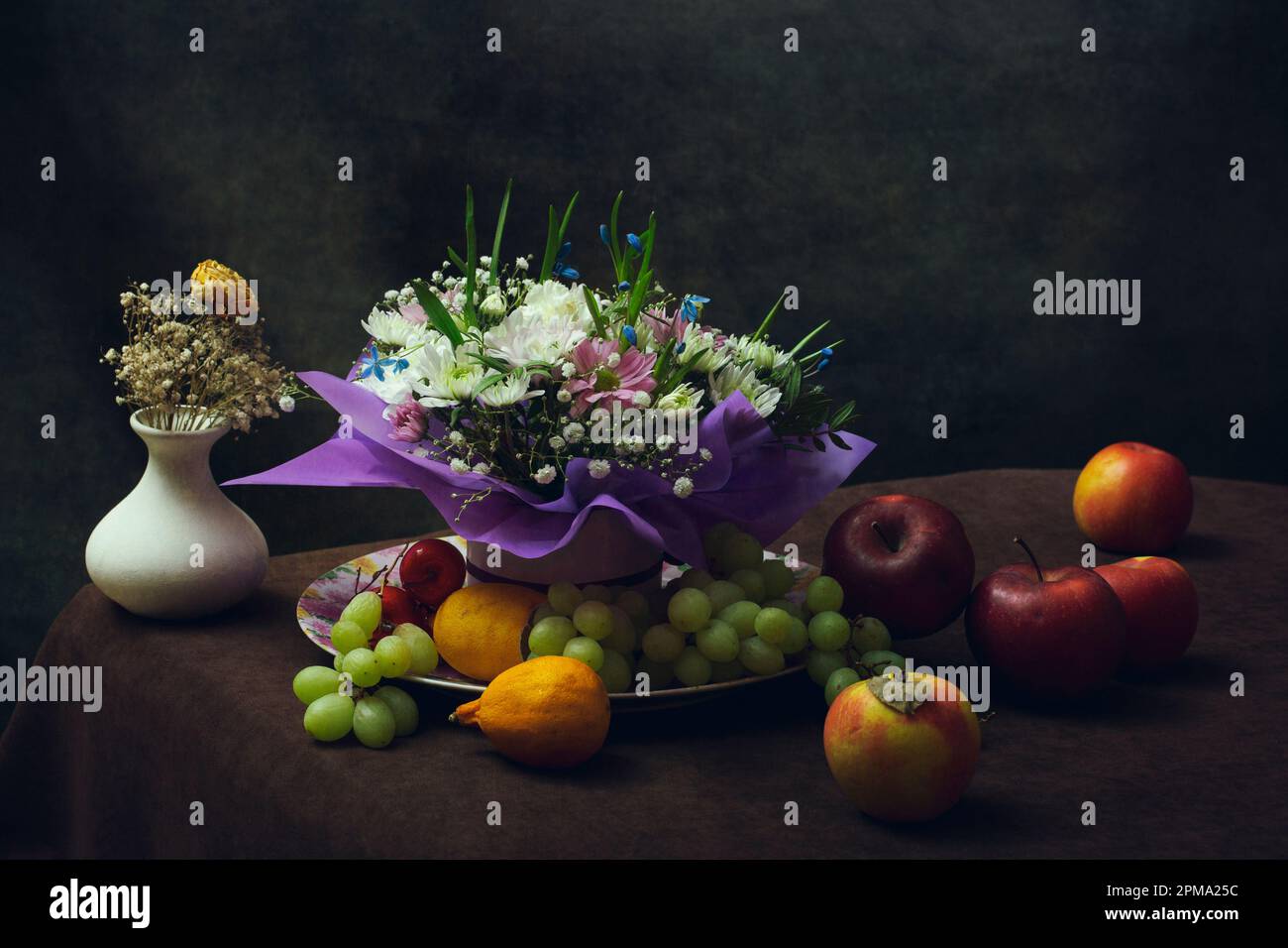 Still life with a bouquet of flowers and fruits Stock Photo - Alamy