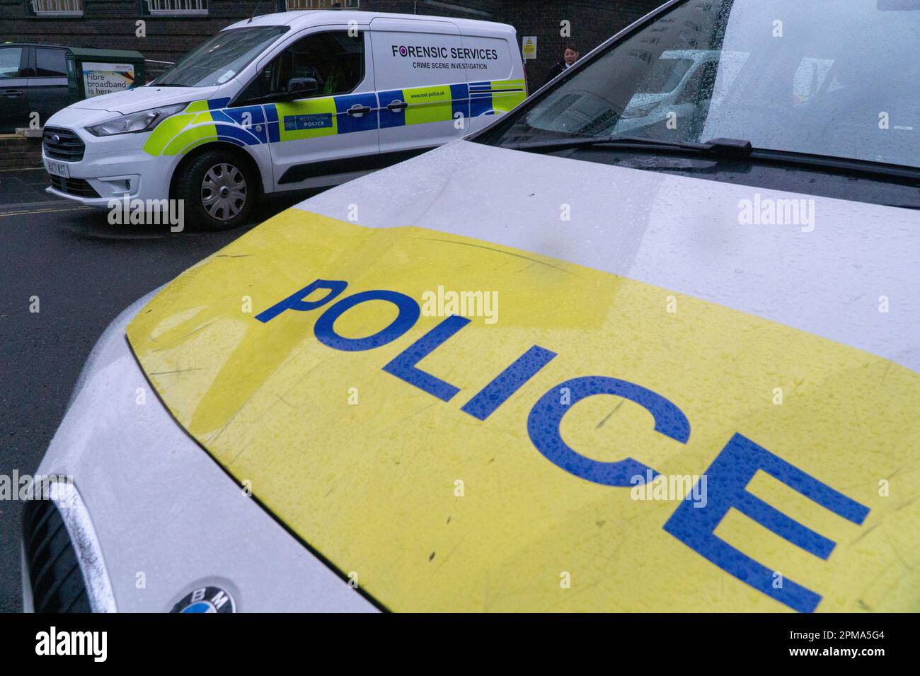 London, UK, 11 April 2023: Metropolitan police cars, including a van serving the forensics unit, parked outside Brixton Police station in South London.  Anna Watson/Alamy Live News Stock Photo