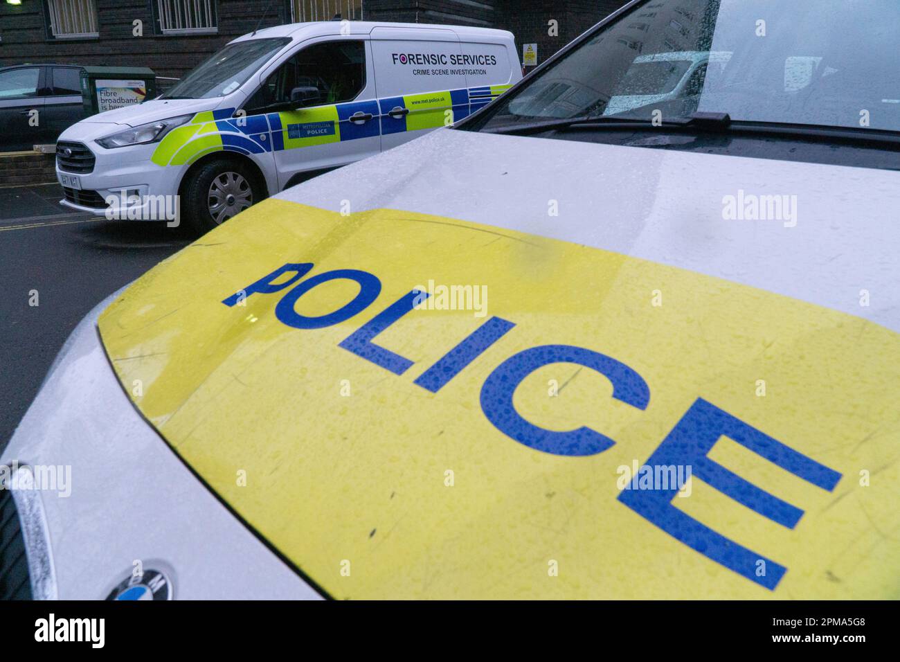 London, UK, 11 April 2023: Metropolitan police cars, including a van serving the forensics unit, parked outside Brixton Police station in South London.  Anna Watson/Alamy Live News Stock Photo