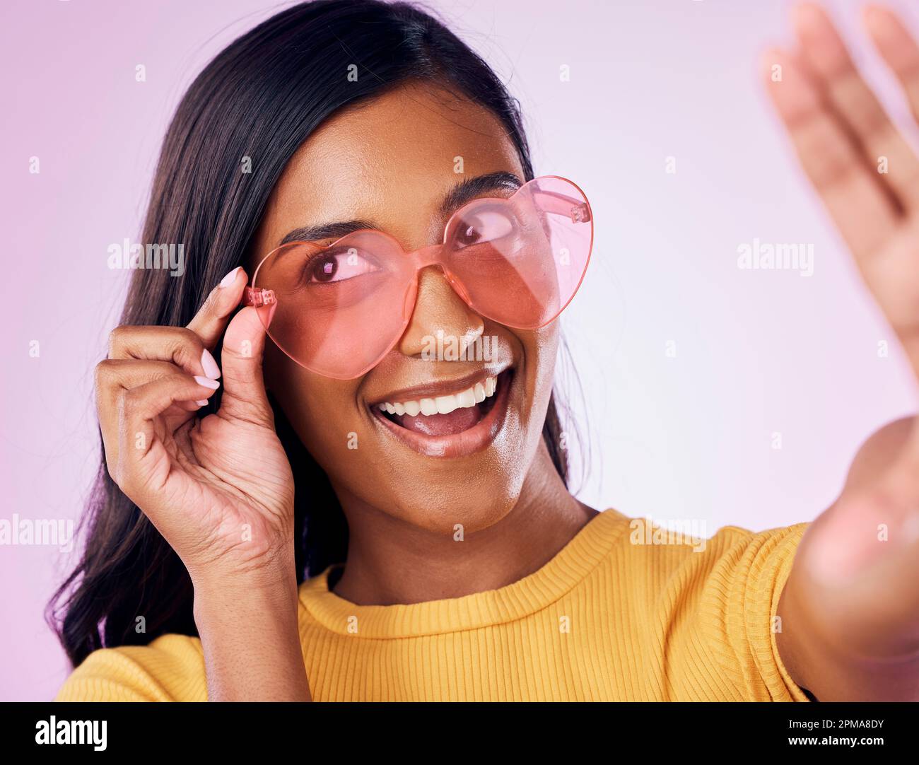 Heart, glasses and selfie by indian woman in studio happy, cheerful and ...