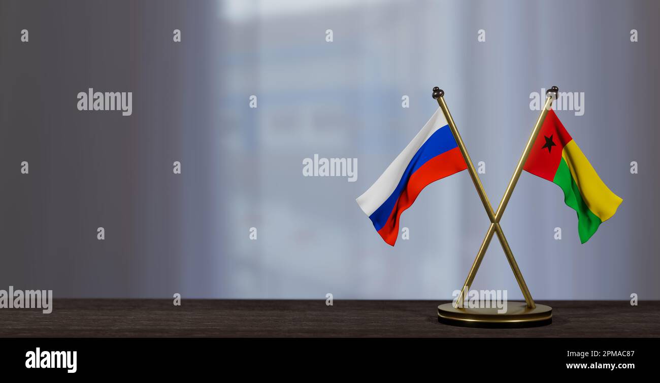 Russia and Guinea-Bissau flags on table. Negotiation between Guinea-Bissau and Russia. on little blur background. 3D work and 3D image Stock Photo