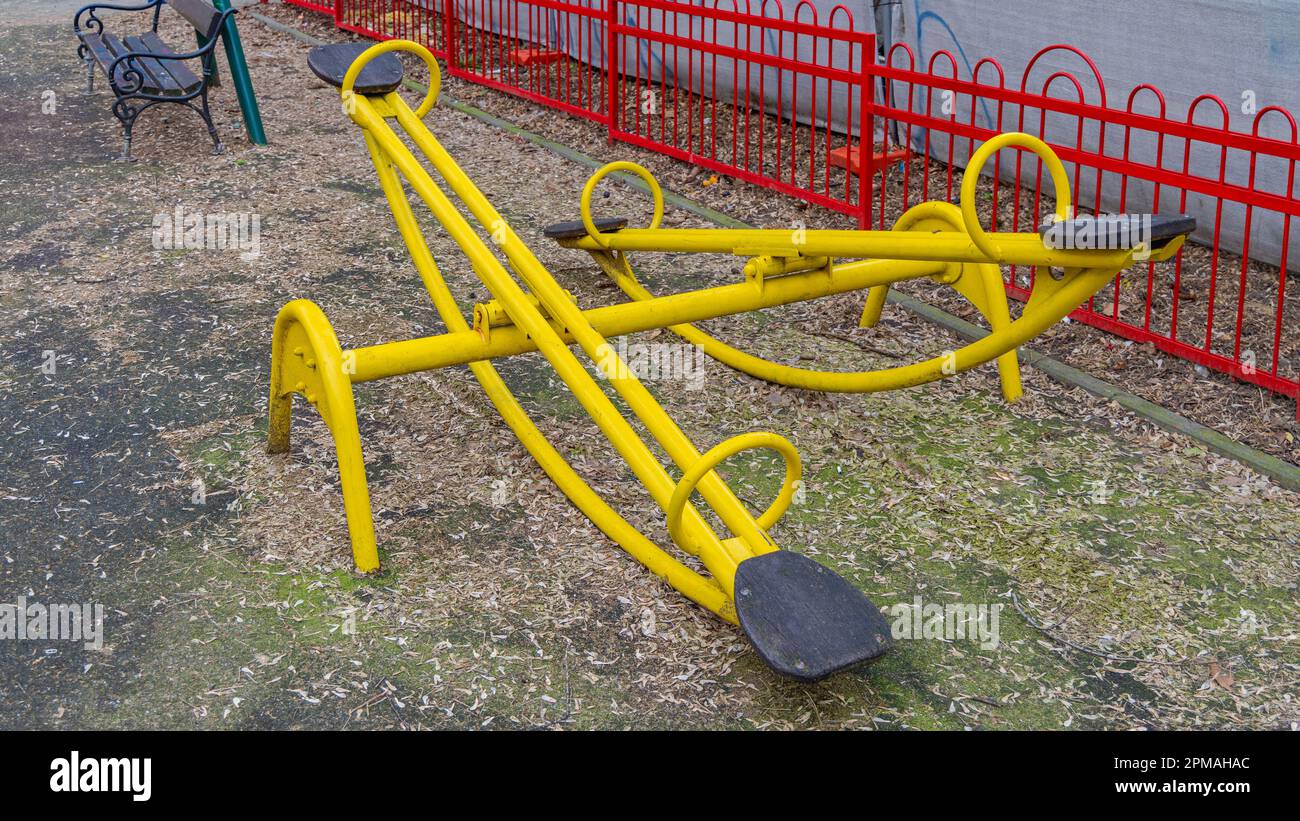 Yellow Teeter Totter Seesaw Teeterboard at Kids Playground Stock Photo