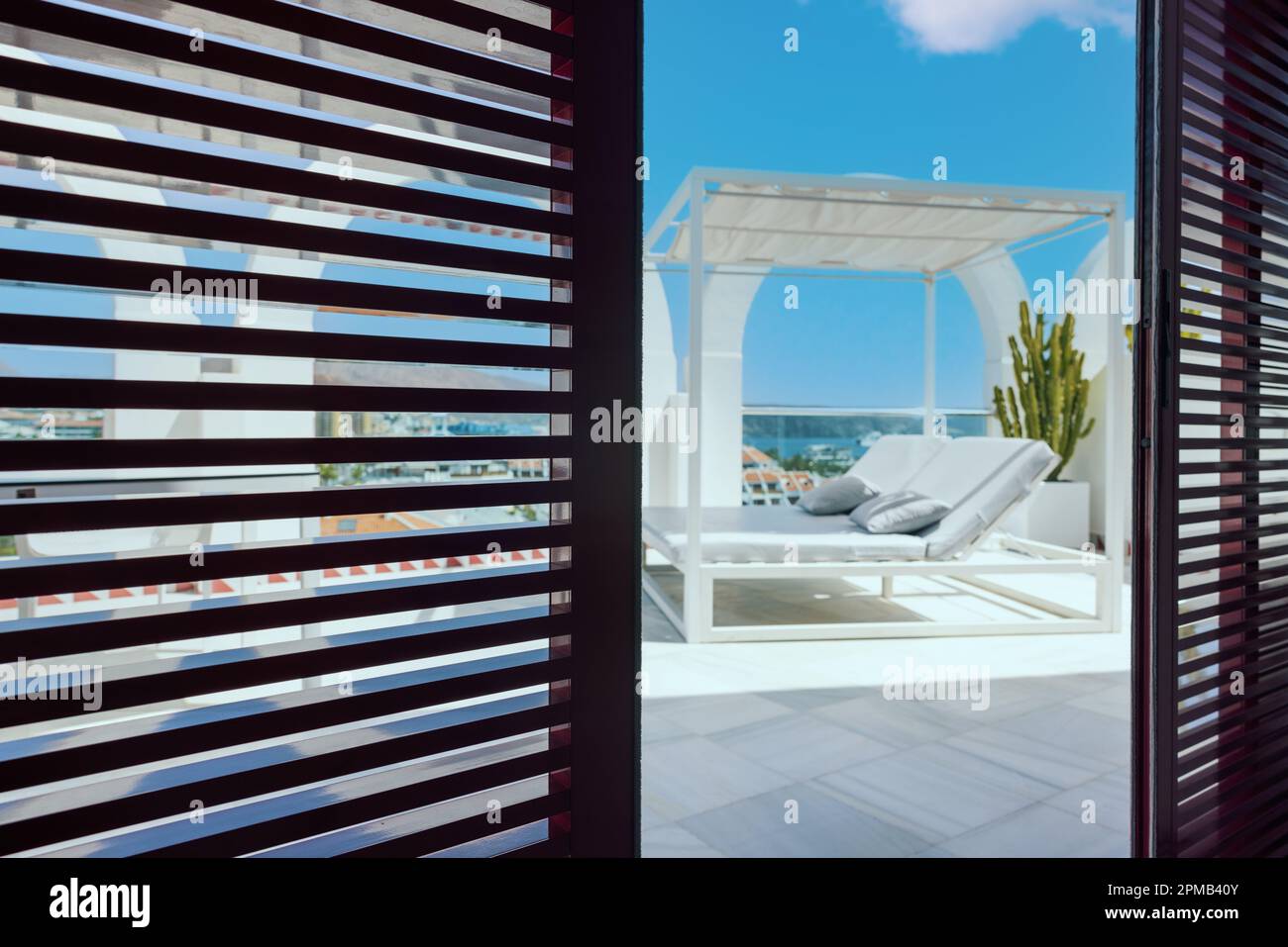 view to the penthouse terrace through the sliding shutter doors Stock Photo