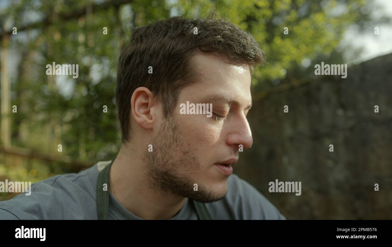 Farmer resting and catching his breath while sitting on the side after