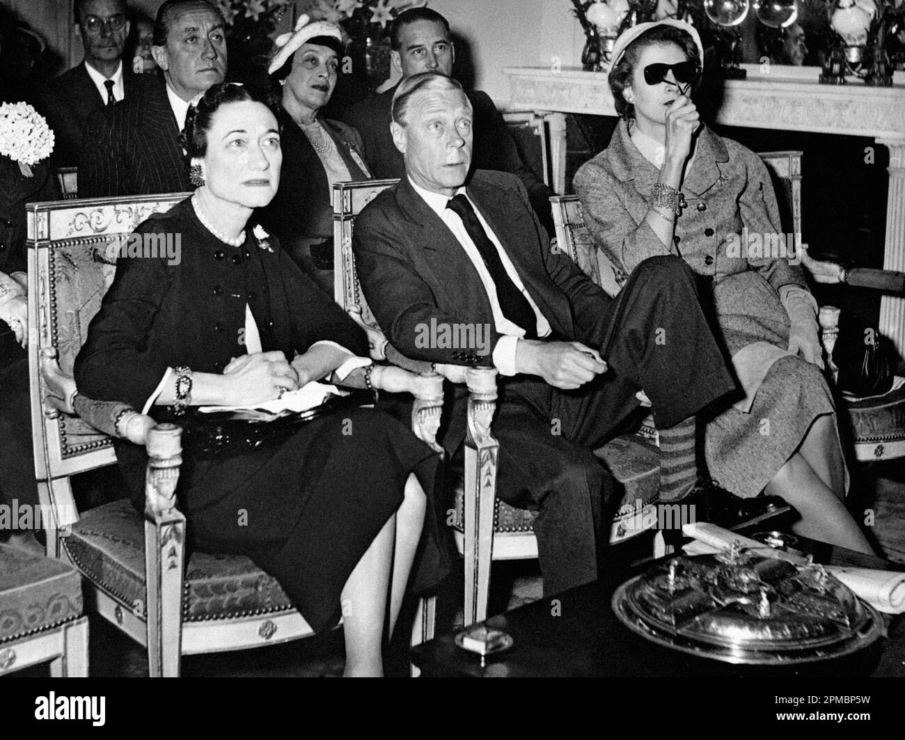 File photo dated 02/06/53 of The (then) Duke and Duchess of Windsor watching the coronation of Queen Elizabeth II on the television screen at the Paris home of Mrs. Margaret Biddle (right). Buckingham Palace has announced, The Duke of Sussex will attend the King Charles III's Coronation but the Duchess of Sussex will remain in California with Prince Archie and Princess Lilibet. Stock Photo