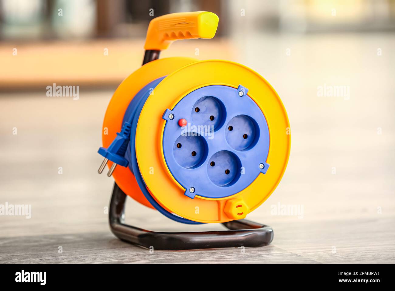 Extension electric cable reel on floor Stock Photo