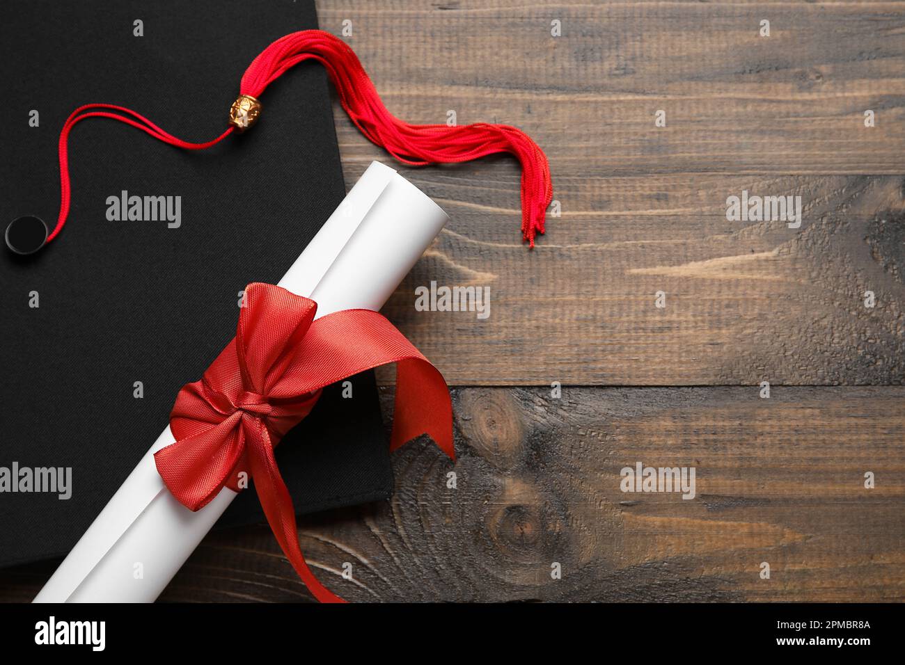 Red Ribbon Graduation Diploma with red ribbon and graduation hat on wooden table Stock Photo ...