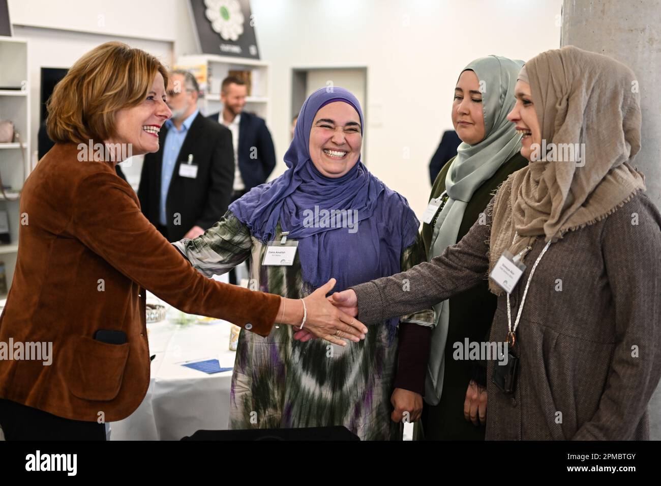 Mainz, Germany. 12th Apr, 2023. Malu Dreyer (SPD, l), Minister President of Rhineland-Palatinate, greets three women wearing the traditional hijab before breaking the fast in the banquet hall of the Islamic Community of Bosniaks (IGDB). During the fasting month of Ramadan, the Muslim communities in Rhineland-Palatinate also invite non-Muslims to break their fast (iftar) in the evening. Credit: Arne Dedert/dpa/Alamy Live News Stock Photo