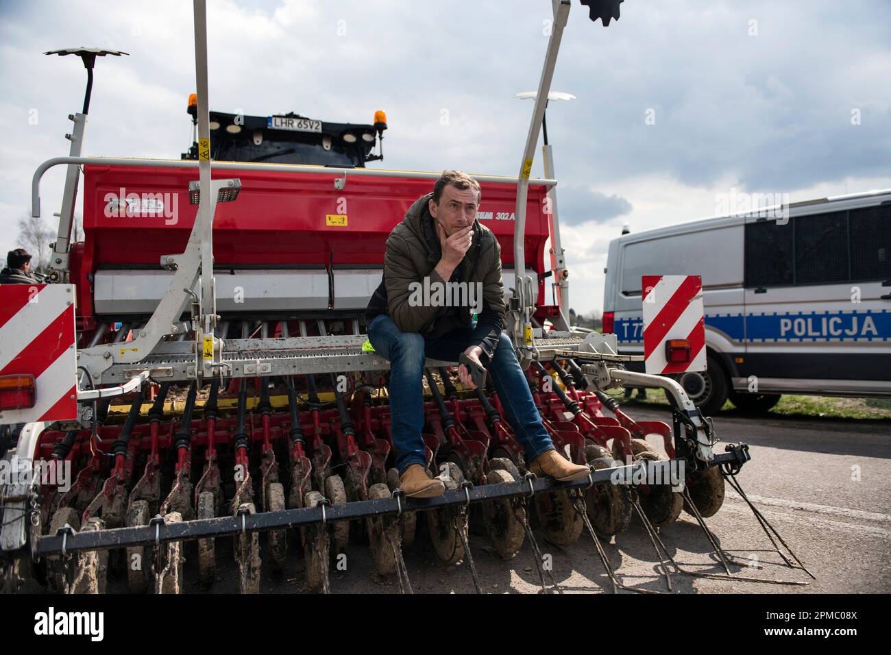 Hrubieszow, Poland. 12th Apr, 2023. A protesting farmer seats on his harvester during the protest at the broad-gauge railway line crossing in Hrubieszow border town. The police prevented the announced Wednesday morning protest of farmers from AgroUnia (AgroUnion) organization led by Michal Kolodziejczak, who were supposed to block the broad-gauge railway line in Hrubieszow border town, where grain from Ukraine enters Poland. As Michal Kolodziejczak said, the protest was reported for 7 days, but farmers are ready to extend it. Credit: SOPA Images Limited/Alamy Live News Stock Photo