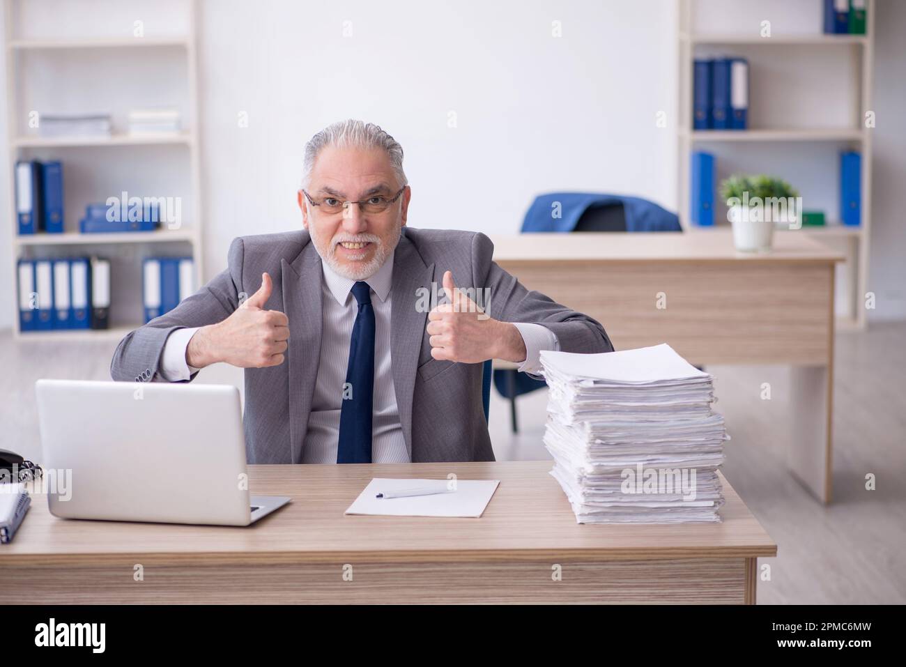 Old businessman employee working at workplace Stock Photo - Alamy