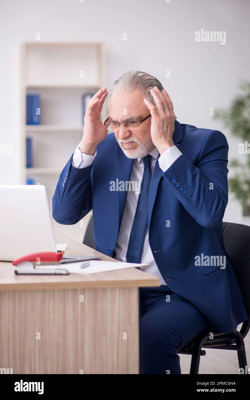 Old businessman employee working at workplace Stock Photo - Alamy