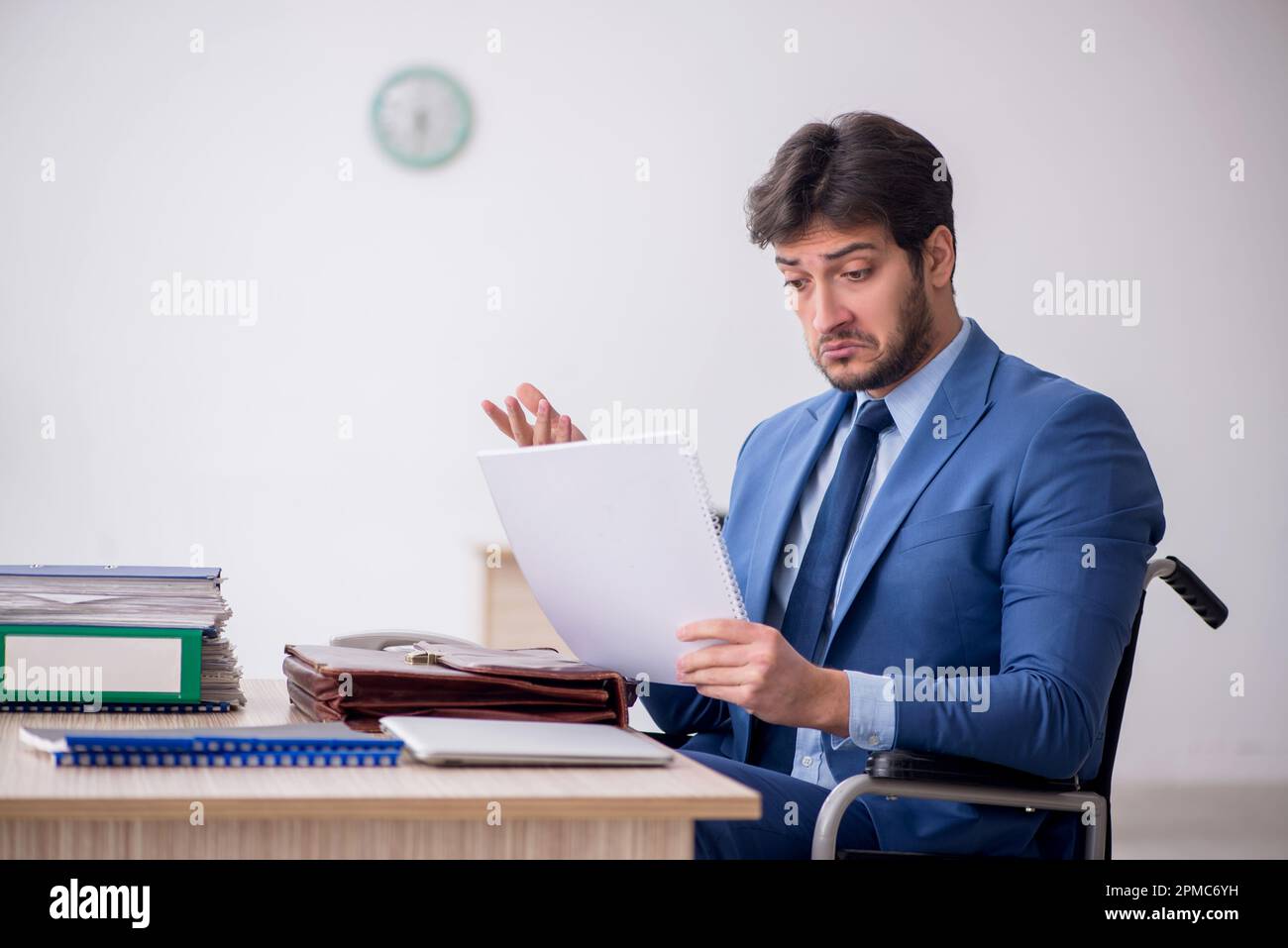 Young businessman employee in wheel-chair Stock Photo