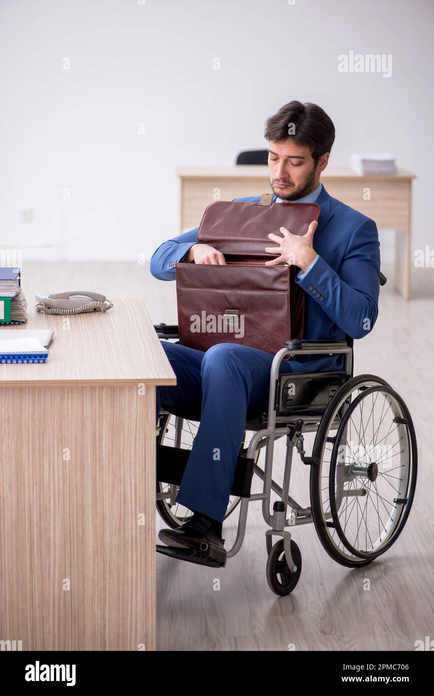 Young businessman employee in wheel-chair Stock Photo