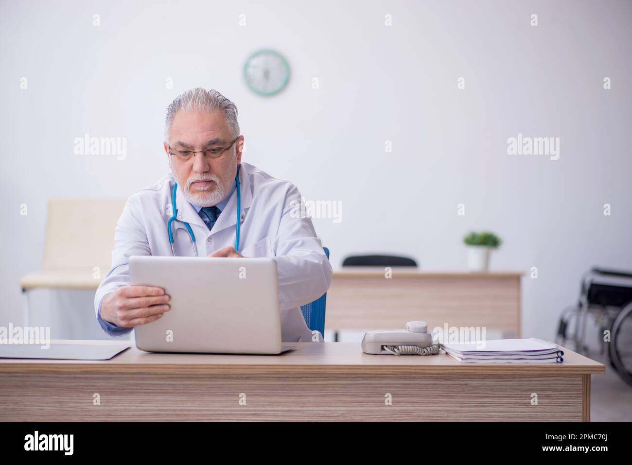 Old doctor in telemedicine concept Stock Photo