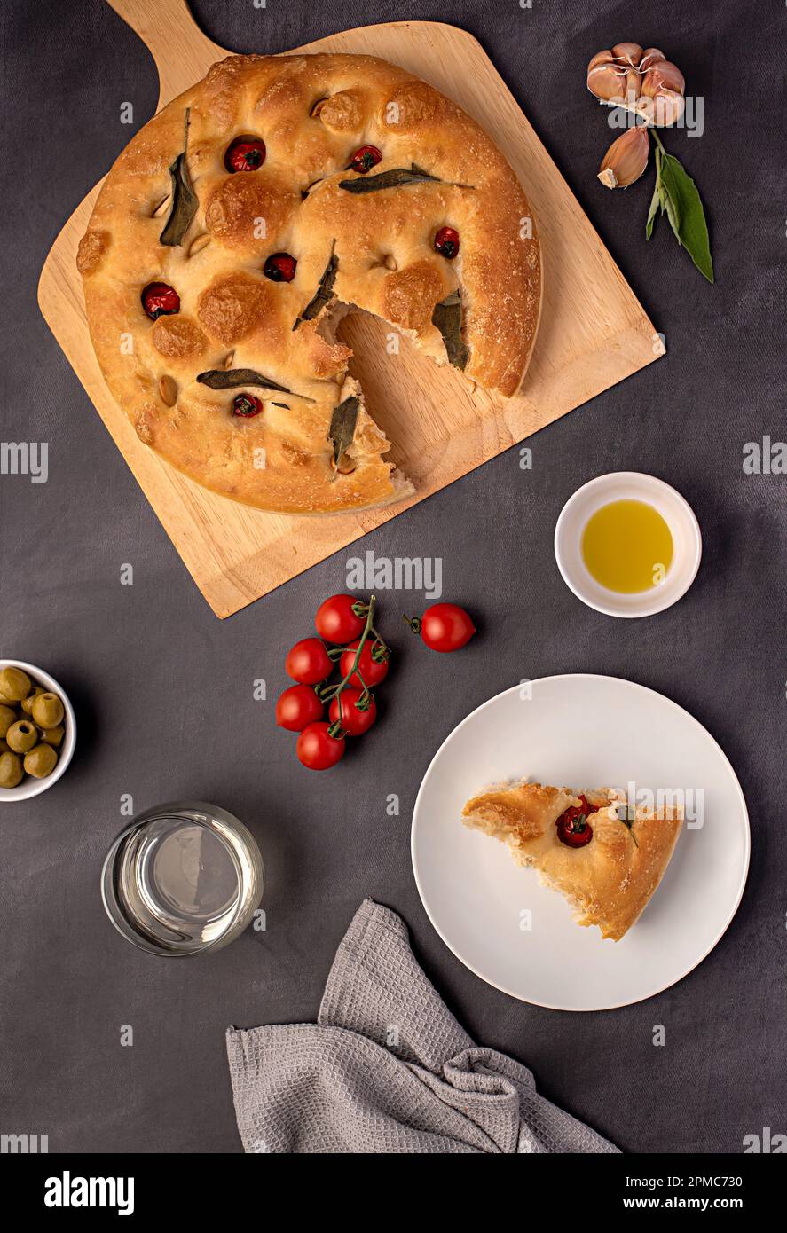 Food photography of sourdough focaccia, white wine, tomato, olive oil