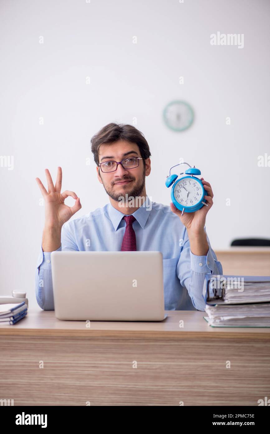 Young employee in time management concept Stock Photo