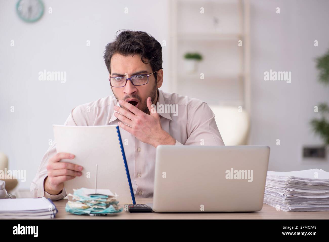 Young accountant sitting at workplace Stock Photo