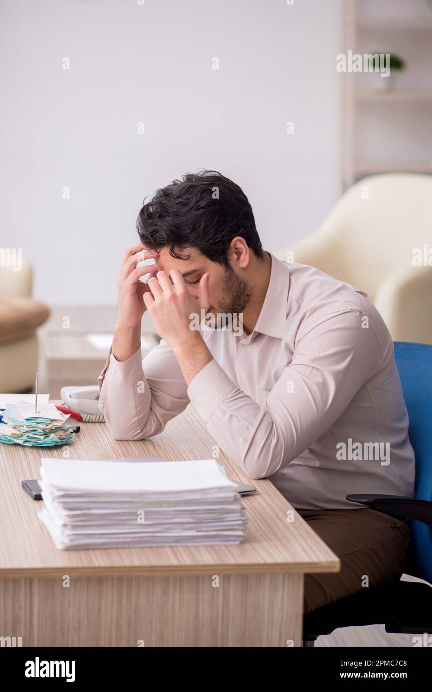 Young accountant sitting at workplace Stock Photo