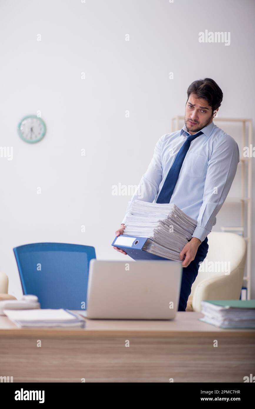 Young businessman employee sitting at workplace Stock Photo