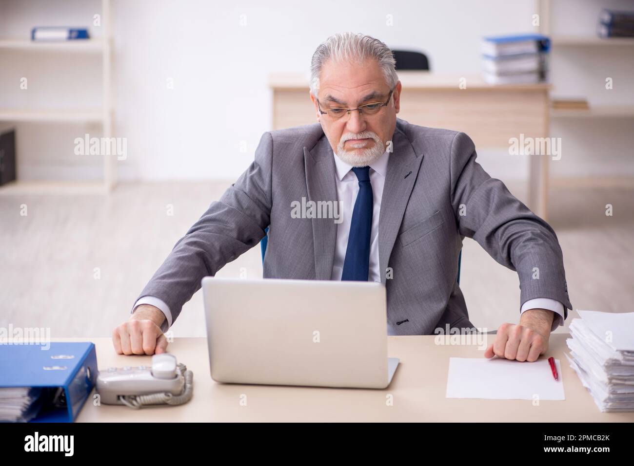 Old boss employee working at workplace Stock Photo - Alamy