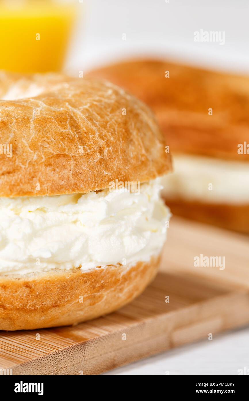 Bagel sandwich with fresh cream cheese for breakfast close up portrait format Stock Photo