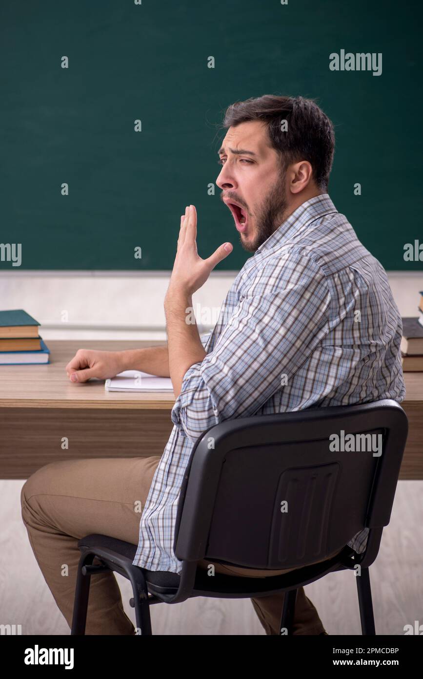 Young student sitting in the classroom Stock Photo - Alamy