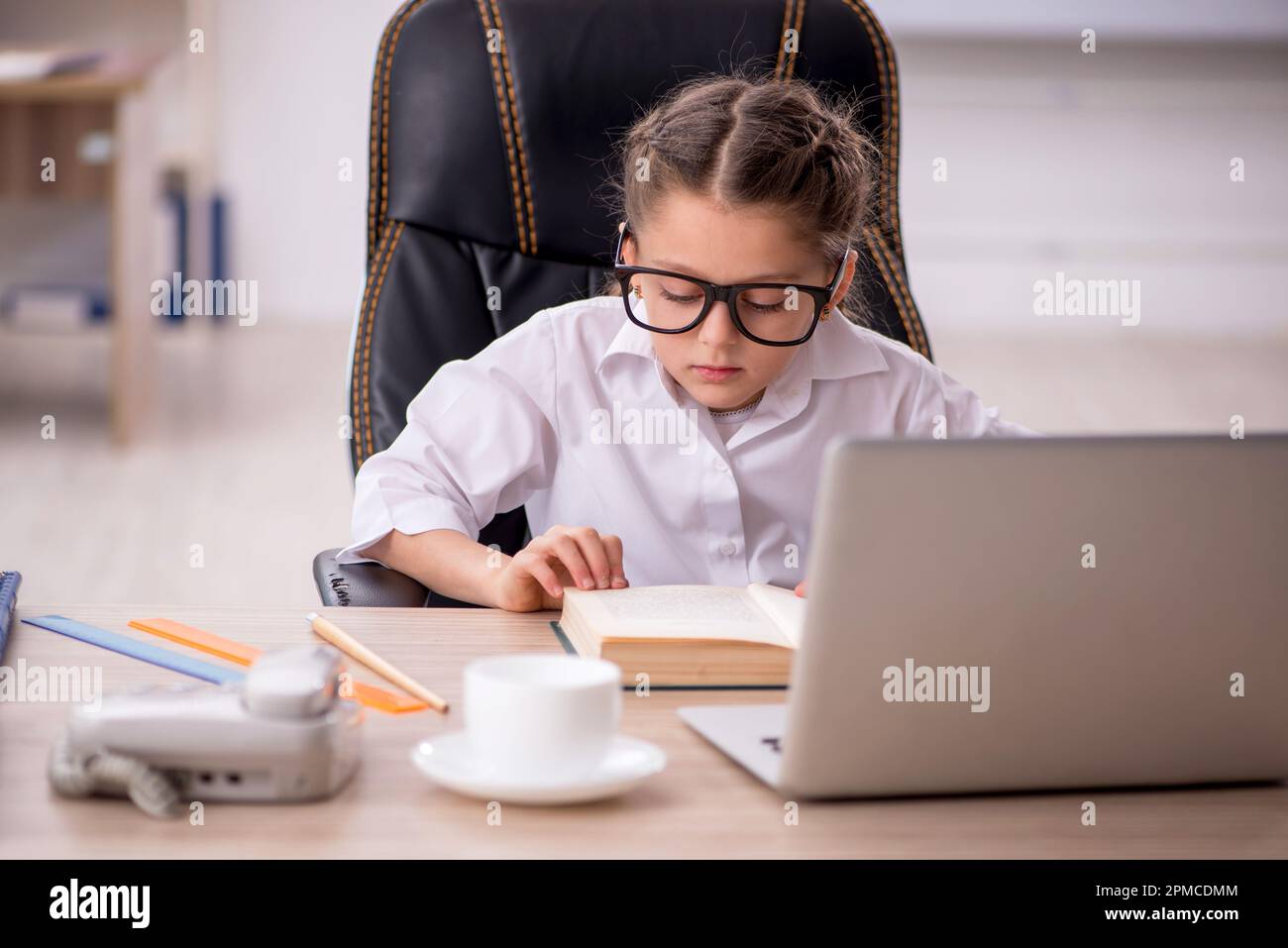 Little girl sitting in the classroom Stock Photo - Alamy