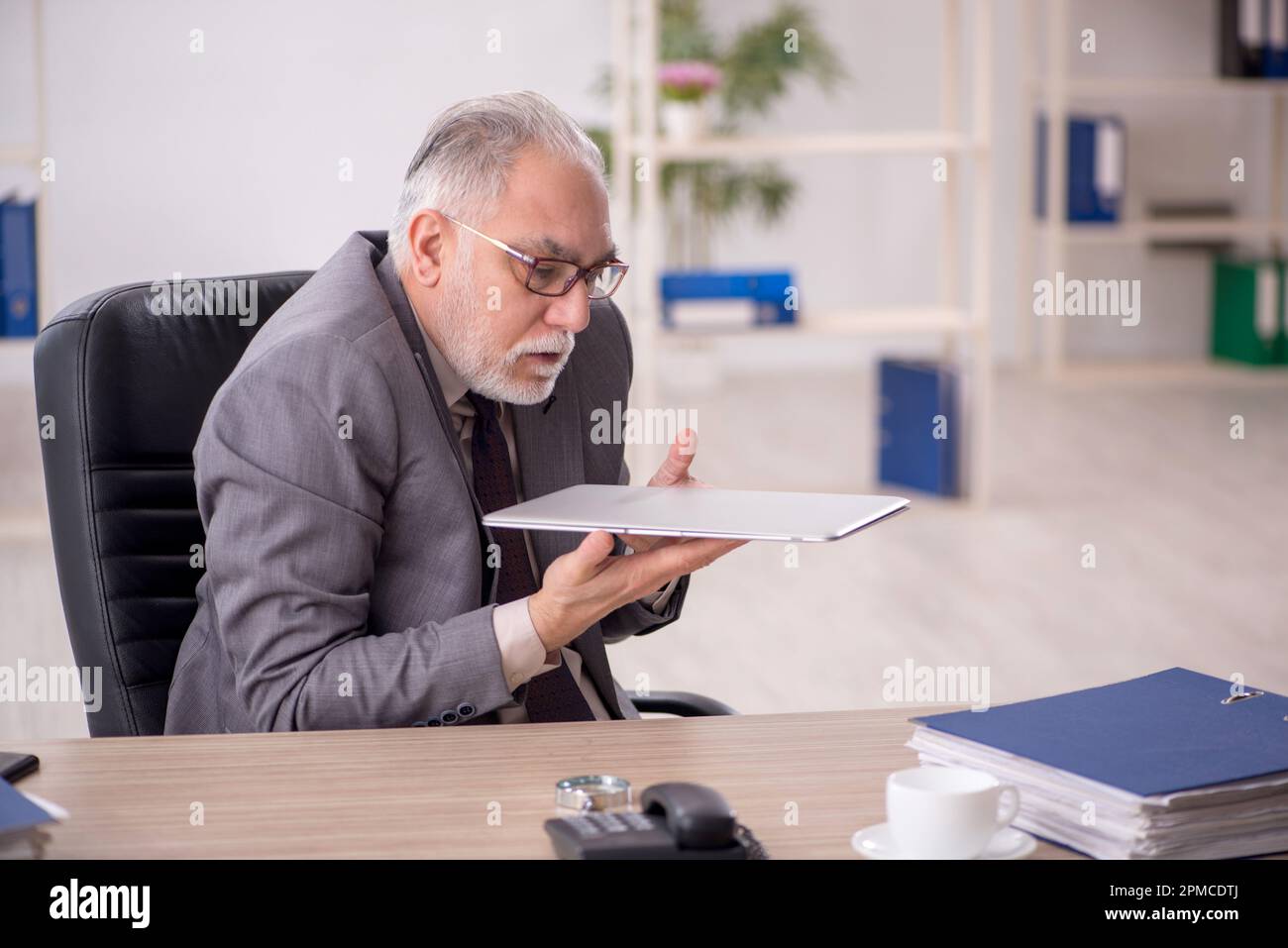 Old businessman employee working at workplace Stock Photo - Alamy