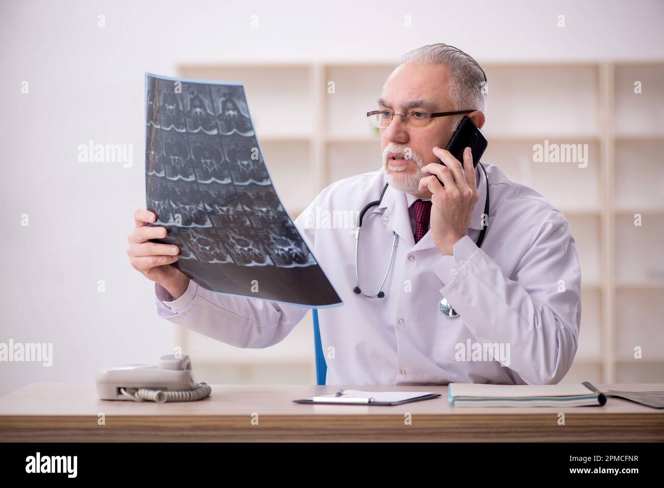 Old doctor radiologist working in the clinic Stock Photo - Alamy