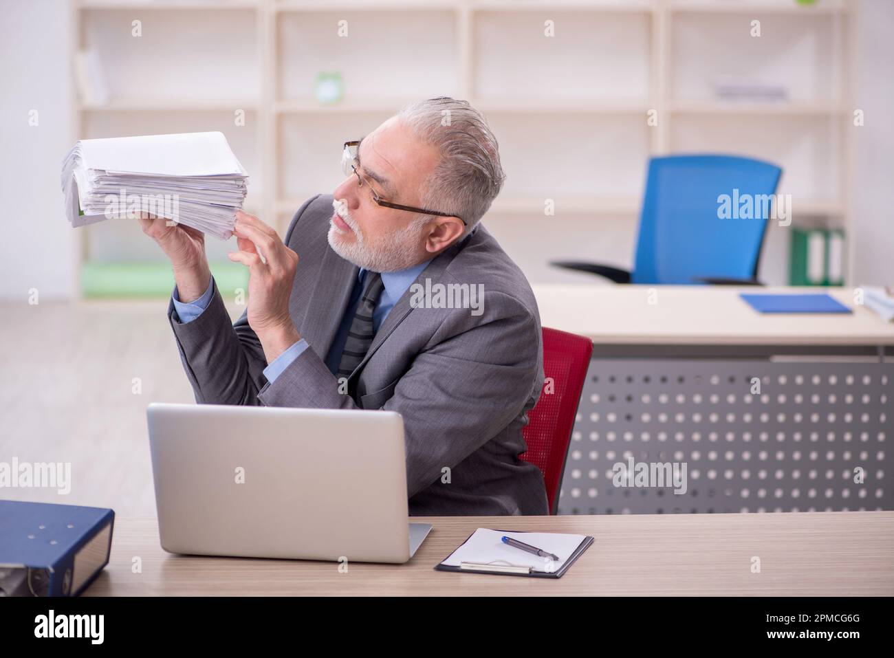 Old businessman employee working at workplace Stock Photo - Alamy