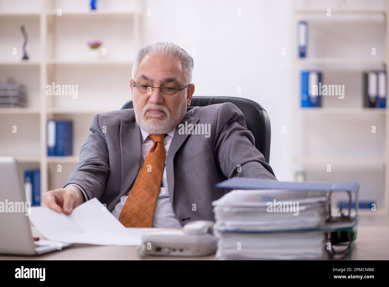 Old businessman employee working at workplace Stock Photo - Alamy