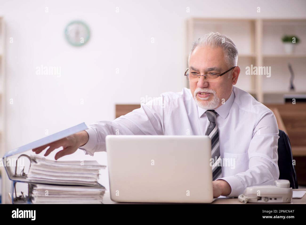 Old boss employee working at workplace Stock Photo - Alamy