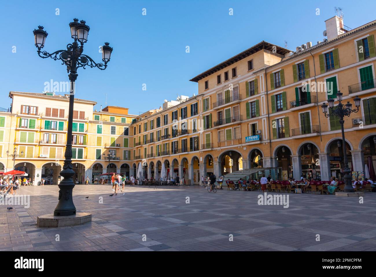 Palma, Mallorca, Balearic Islands, Spain. July 21, 2022 - The buildings of the Plaza Mayor in Palma, the main square surrounded by arcades, with terra Stock Photo