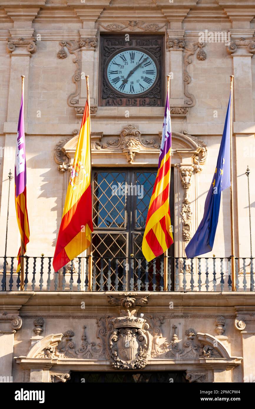 Palma, Mallorca, Balearic Islands, Spain. July 21, 2022 - Balcony on the facade of the town hall, with the flags of the European Community, the Spanis Stock Photo