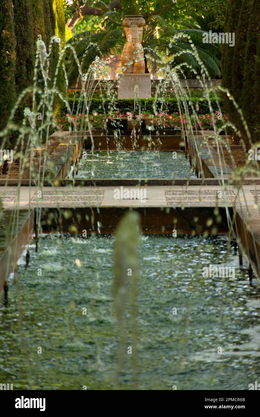 Palma, Mallorca, Balearic Islands, Spain. July 21, 2022 - Fountain of the Huerto del Rey, or king's garden public gardens, by Gabriel Alomar. At backg Stock Photo