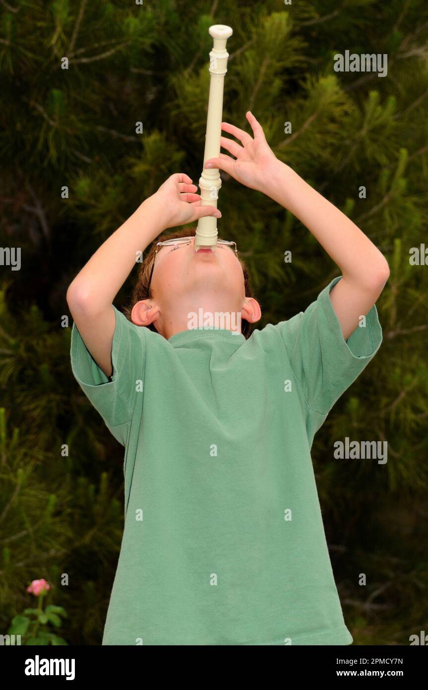 Young boy playing a recorder musical instrument Stock Photo Alamy