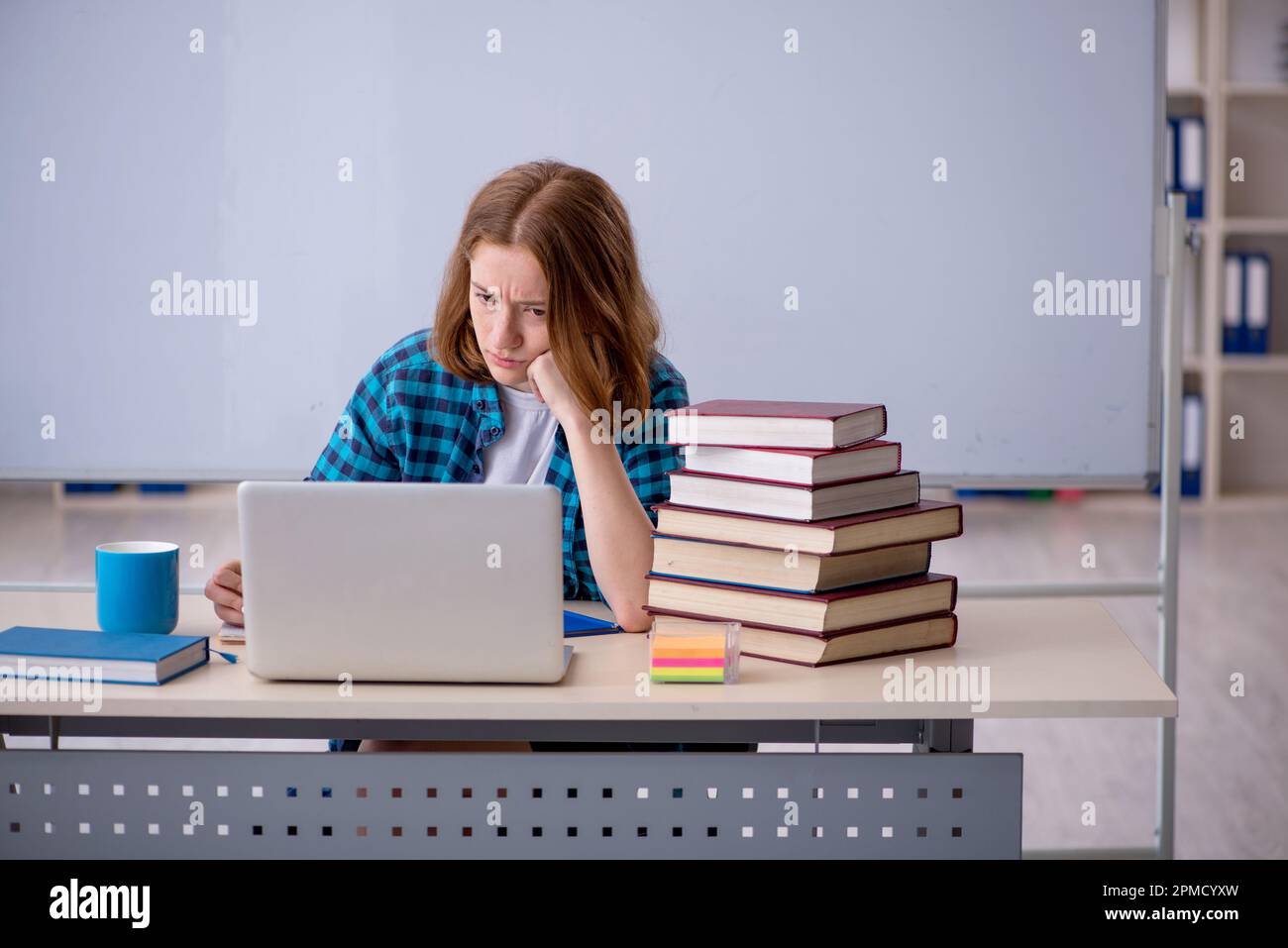 Young girl student preparing for exams in the classroom Stock Photo - Alamy