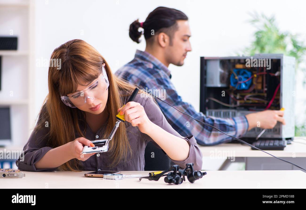 The two technicians working at computer warranty center Stock Photo