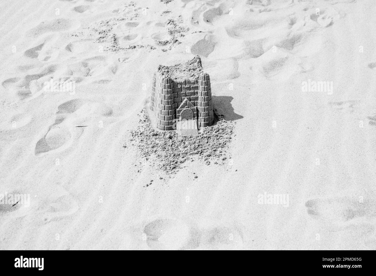 Building sand castles on Virginia Beach on a sunny day.  Also serves as a concept of building sand castle next to the shore. Stock Photo