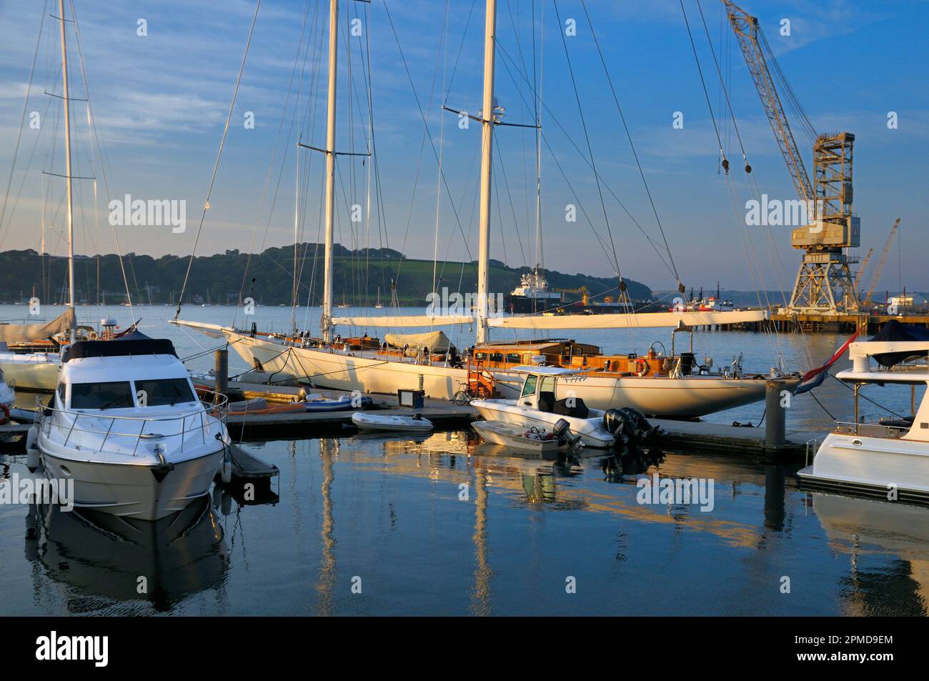 Soft golden sunlight on a cutter sailing boat moored in Falmouth Harbour, Cornwall, England, UK Stock Photo