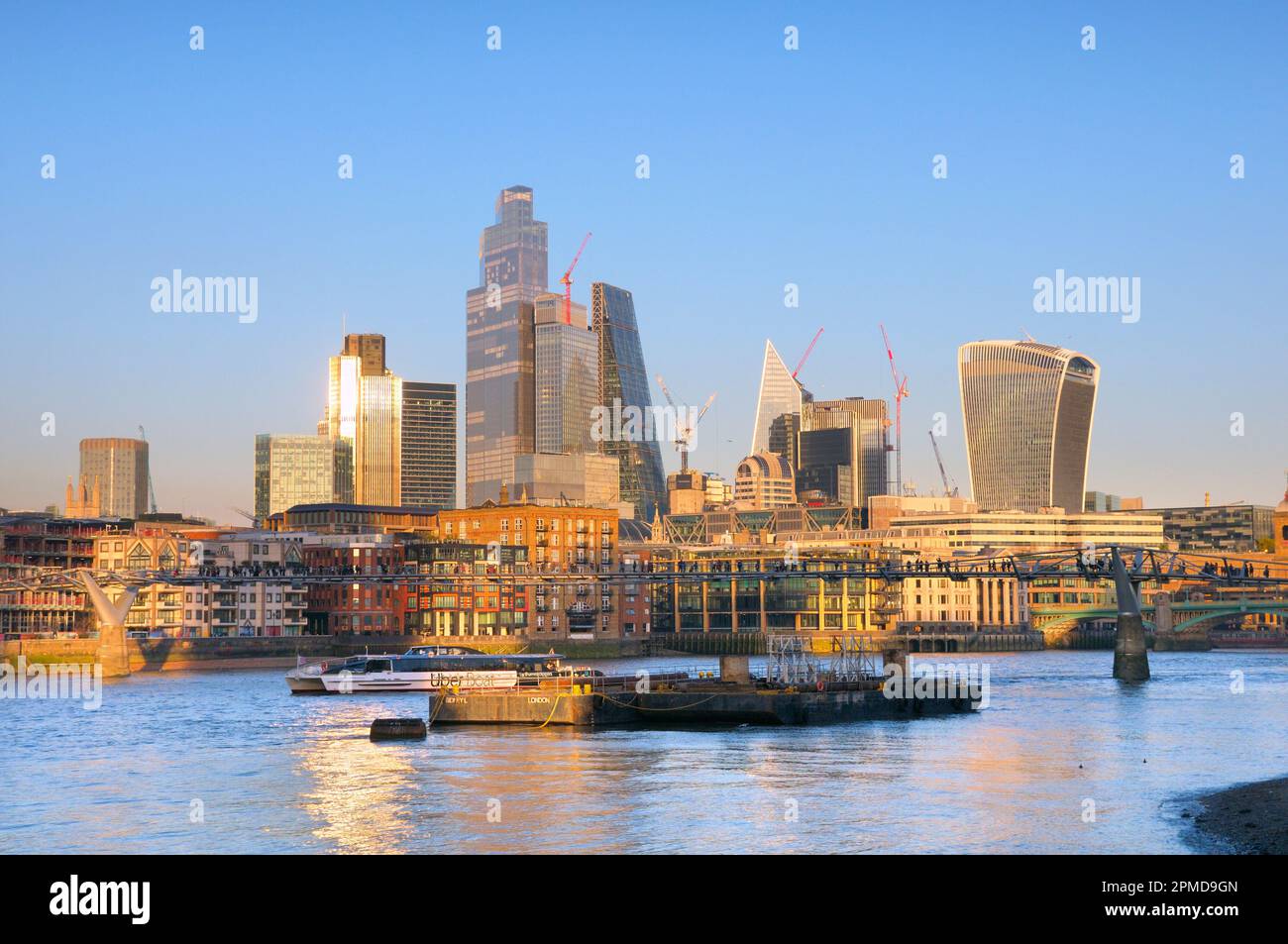 City of London skyline and Millennium Bridge seen from across the River Thames, London, England UK incl. 22 Bishopsgate, 52 Lime Street, Walkie Talkie Stock Photo