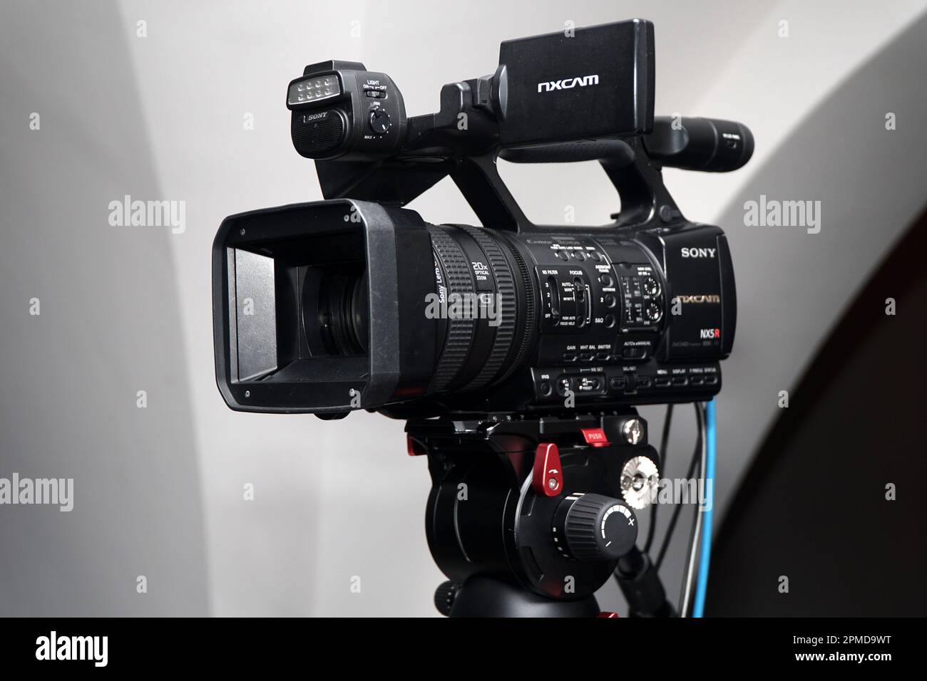 Professional video Camcorder camera Sony NXCAM HXR-NX5R on a tripod for broadcasting, recording for streaming corporate live event Stock Photo