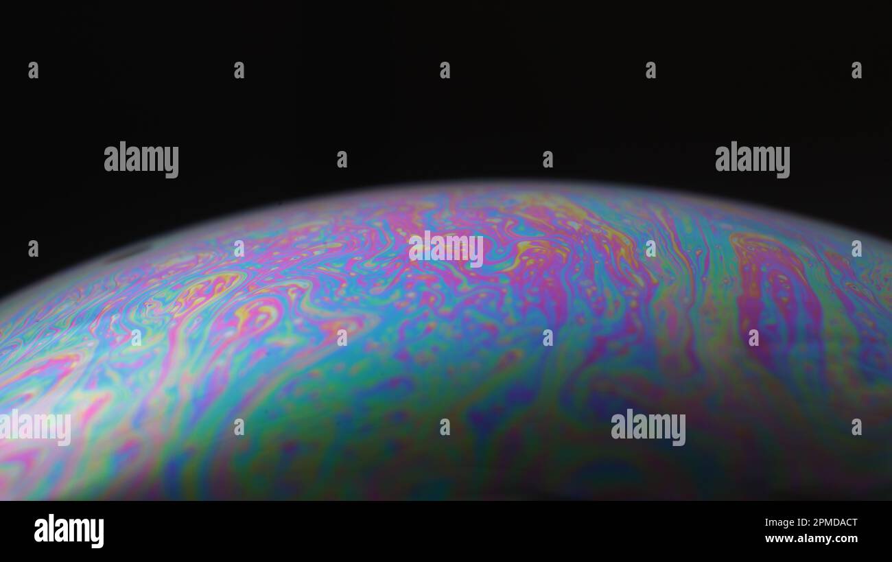Macro of an iridescent soap bubble film forming psychedelic patterns on ...