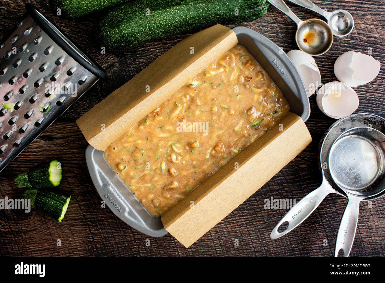 Loaf Pan Filled with Zucchini Bread Batter on a Wood Table Nonstick
