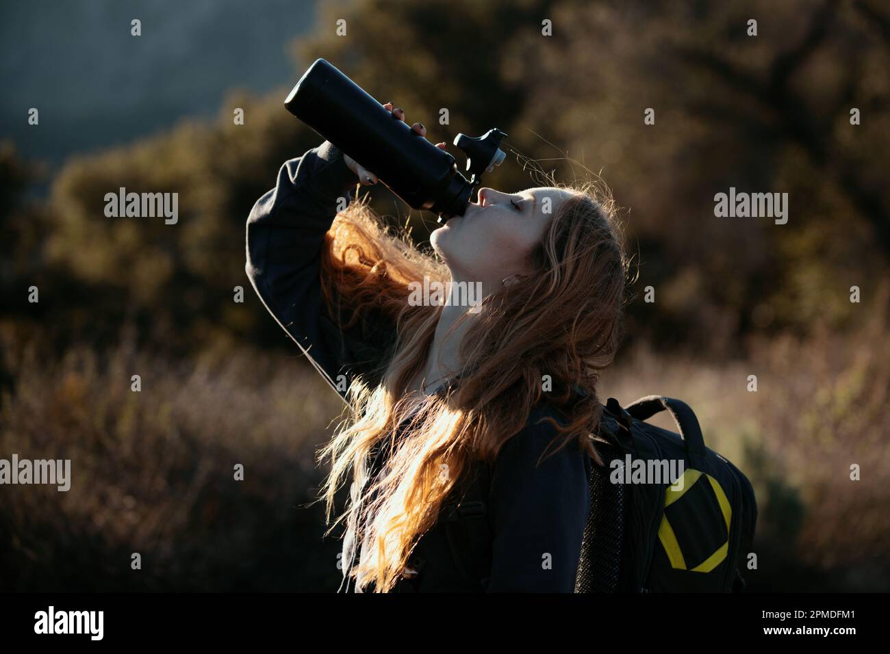 Woman traveler drink water. Female hiker with backpack at mountain ...
