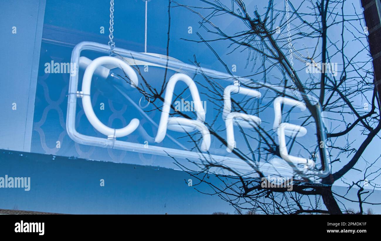 Neon cafe sign behind window Stock Photo
