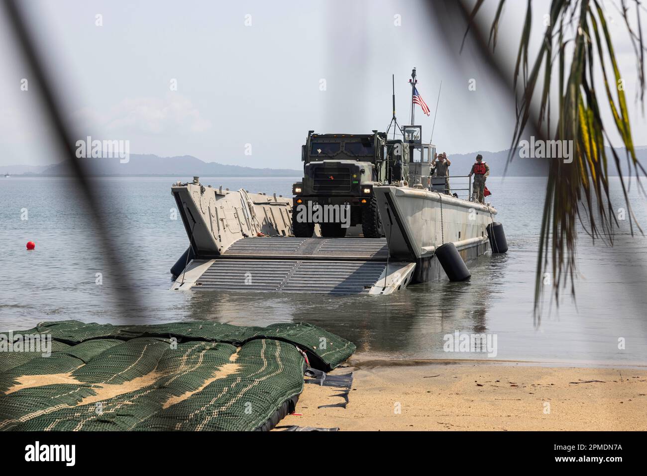 A U.S. Army Landing Craft Mechanized carries a Marine Medium Tactical Vehicle Replacement ashore, in preparation for Balikatan 23 at Camp Agnew, Casiguran, Philippines, April 8, 2023. Balikatan is an annual exercise between the Armed Forces of the Philippines and U.S. military designed to strengthen bilateral interoperability, capabilities, trust, and cooperation built over decades shared experiences. (U.S. Marine Corps photo by Staff Sgt. Danny Gonzalez) Stock Photo